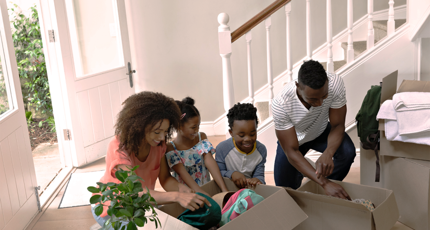 Family in house packing up boxes